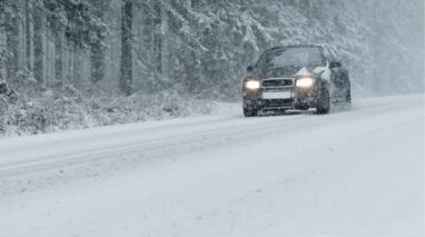 Front view of a car driving in the snow