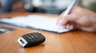 close up of car keys with hand writing on paper on the background