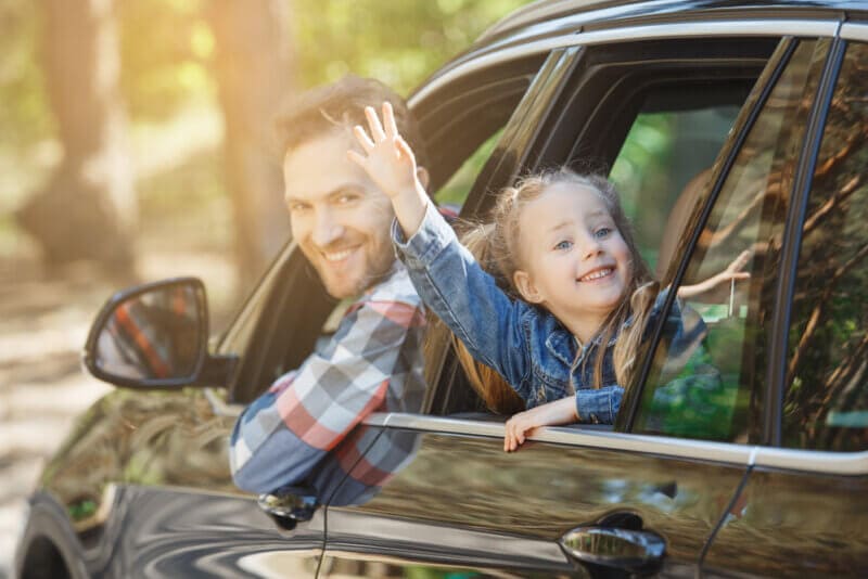 happy father and daughter in car