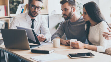 independent insurance agent with customers looking at a policy