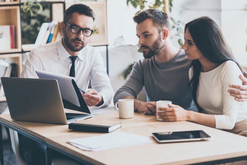 independent insurance agent with customers looking at a policy