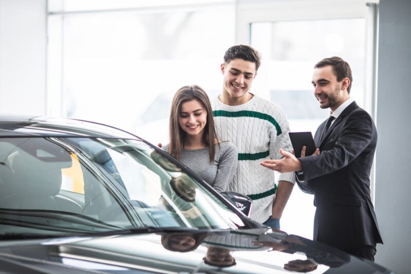 couple looking at new car