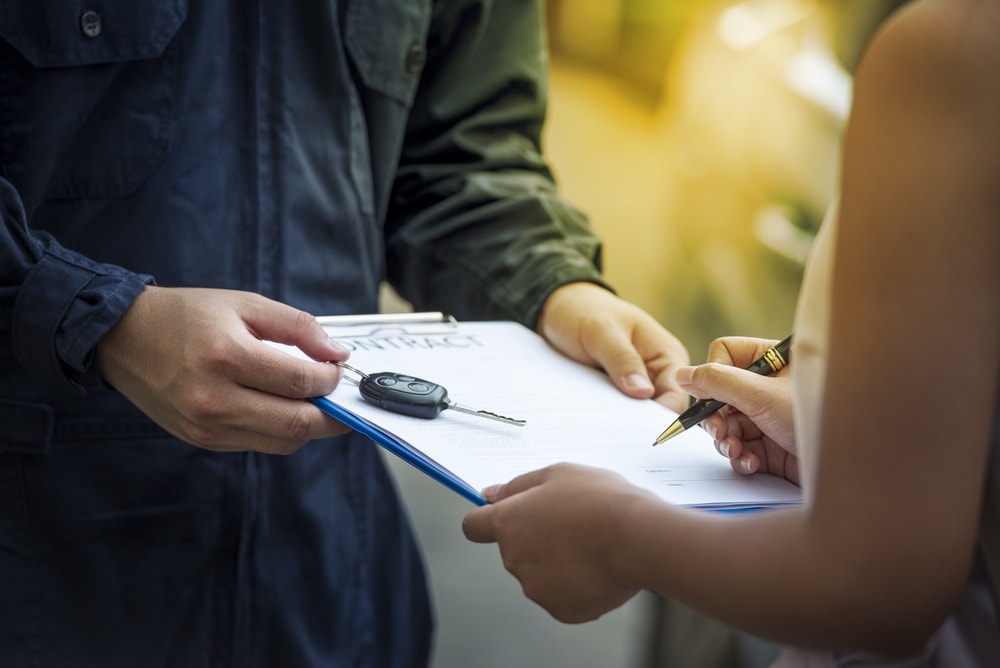 car salesman with lease agreement