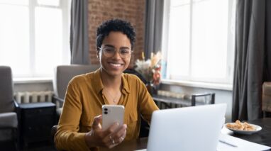 Professional insurance sales agent in front of laptop