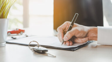 person signing auto lease document