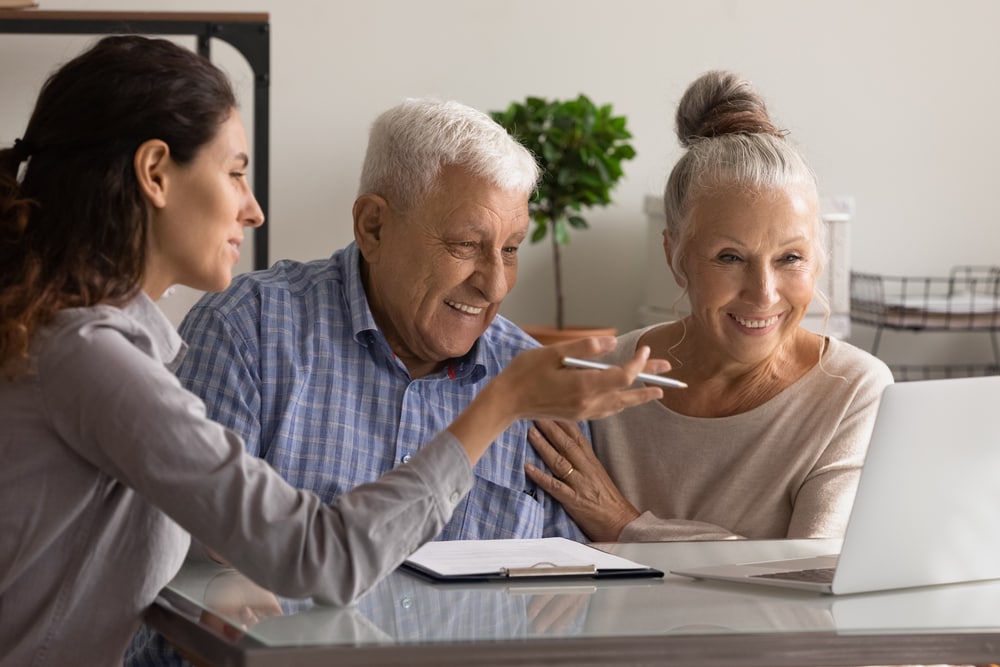 Insurance sales agent helps happy older couple 