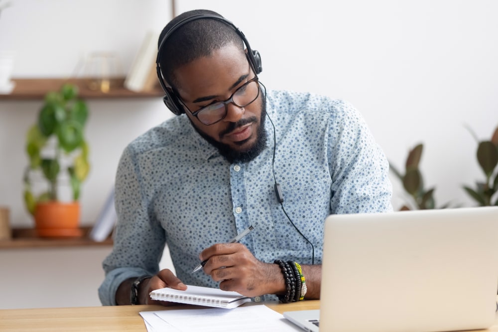 African American male insurance agent takes an online course