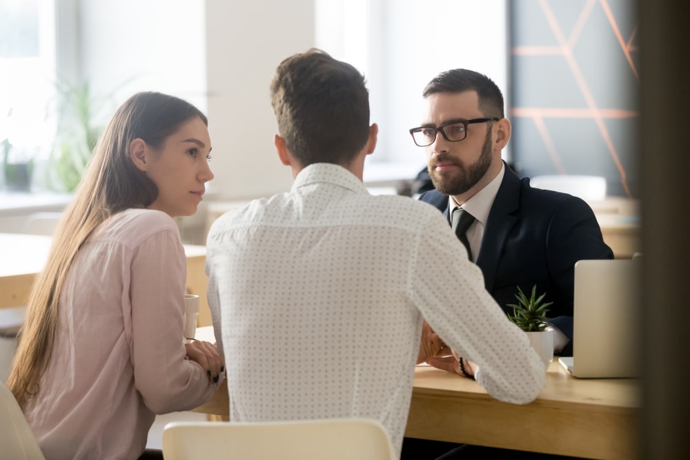 Insurance agent listens carefully to couple