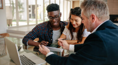 An insurance agent works with a biracial couple