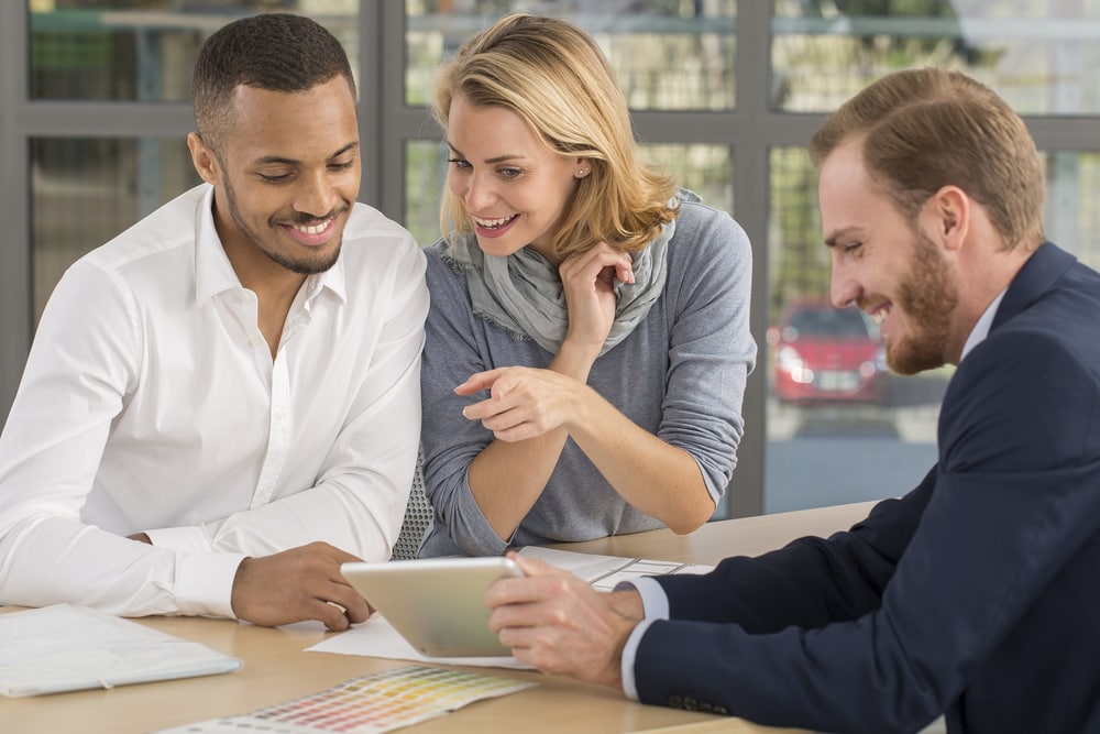 Bi-racial couple works with insurance agent to buy insurance for millennials