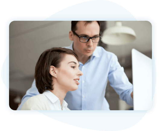 Man and woman in fron of a computer in an office setting