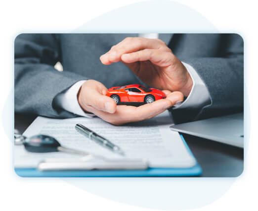 Businessperson hand holding red car with other hand providing a shelter.
